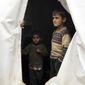 Syrian children, evacuated from Aleppo, stand inside a tent at a refugee camp near Idlib, Syria, Friday, Dec. 16, 2016. Turkey&#39;s Foreign Minister Mevlut Cavusoglu says 7,500 civilians have been evacuated from the Syrian city of Aleppo and that he has reached out to Tehran in a bid to keep the process on track.(AP Photo)