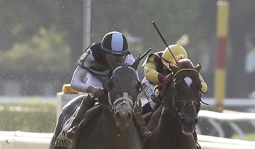 Tapwrit, left, and Irish War Cry race to the finish during the 149th running of the Belmont Stakes horse race, Saturday, June 10, 2017, in Elmont, N.Y. Tapwrit won the race. (AP Photo/Mary Altaffer)