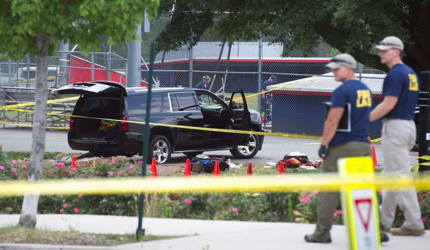 An SUV at the ballfield had a bullet hole in the windshield and a flat tire after the gunman shot at a U.S. Capitol Police officer who was returning fire to protect the lawmakers. (Associated Press)