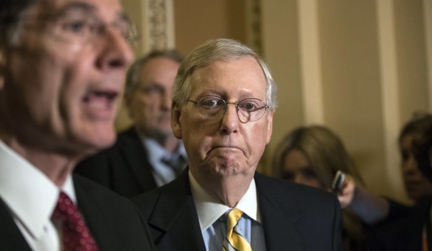 Senate Majority Leader Mitch McConnell, R-Ky., joined by Sen. John Barrasso, R-Wyo., left, tells reporters he is delaying a vote on the Republican health care bill while GOP leadership works toward getting enough votes, at the Capitol in Washington, Tuesday, June 27, 2017. (AP Photo/J. Scott Applewhite)