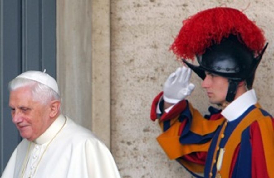 Pope Benedict XVI is saluted by a Swiss guard at the Vatican in November 2007. The head of the Vatican's Swiss Guard has resigned over a dispute that could affect the Pope's security for his U.S. visit.