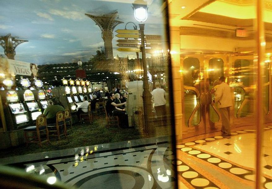 ** FILE ** Tourists play slot machines at the Paris hotel-casino in Las Vegas. (Associated Press)