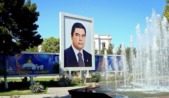 ** FILE ** Following the lead of his predecessor, Turkmenistan&#x27;s new president, Gurbanguly Berdymukhamedov, made sure in 2007 that his countrymen knew who he was, with portraits springing up everywhere, such as this one next to a fountain in the capital, Ashgabat. (Joshua Kucera/The Washington Times)