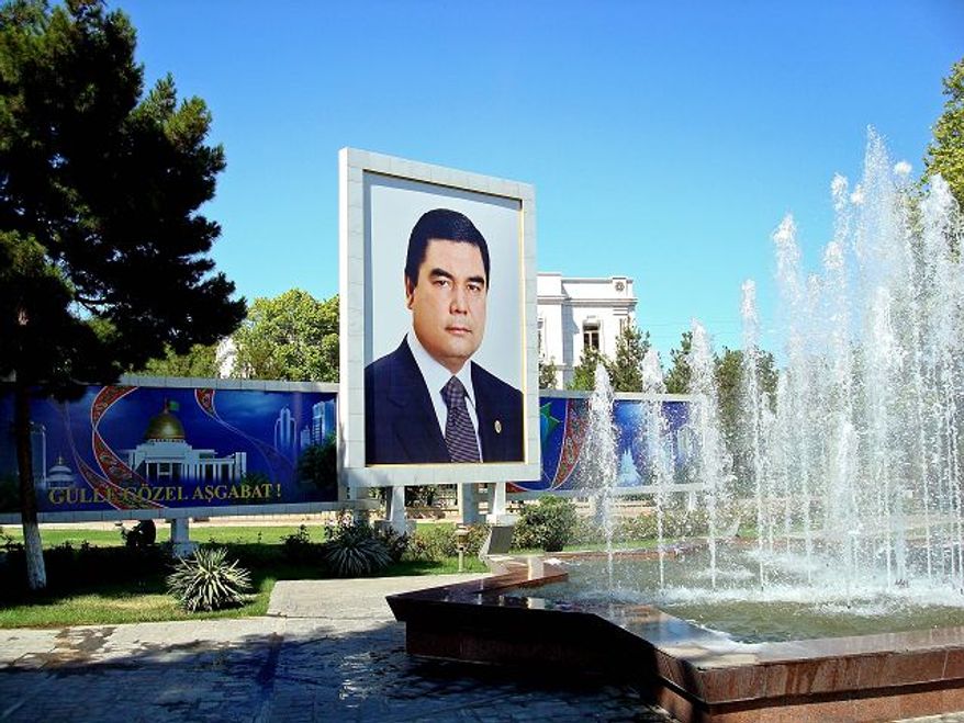 ** FILE ** Following the lead of his predecessor, Turkmenistan's new president, Gurbanguly Berdymukhamedov, made sure in 2007 that his countrymen knew who he was, with portraits springing up everywhere, such as this one next to a fountain in the capital, Ashgabat. (Joshua Kucera/The Washington Times)