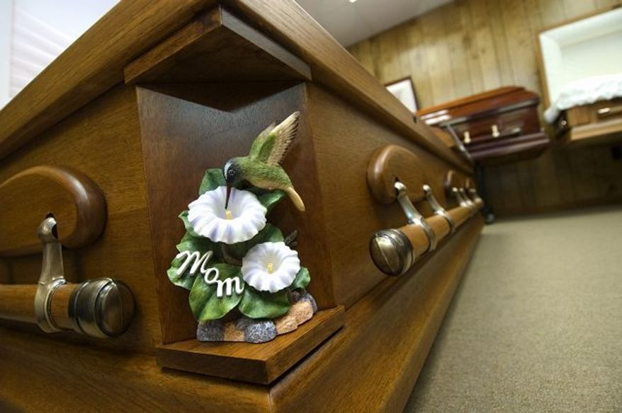 A casket at Keeney and Basford Funeral Home in Frederick, Md., displayed a decorative symbol. Casket can have the standard corners replaced with a variety of pieces, allowing families to create a casket that is more about personality than tradition.