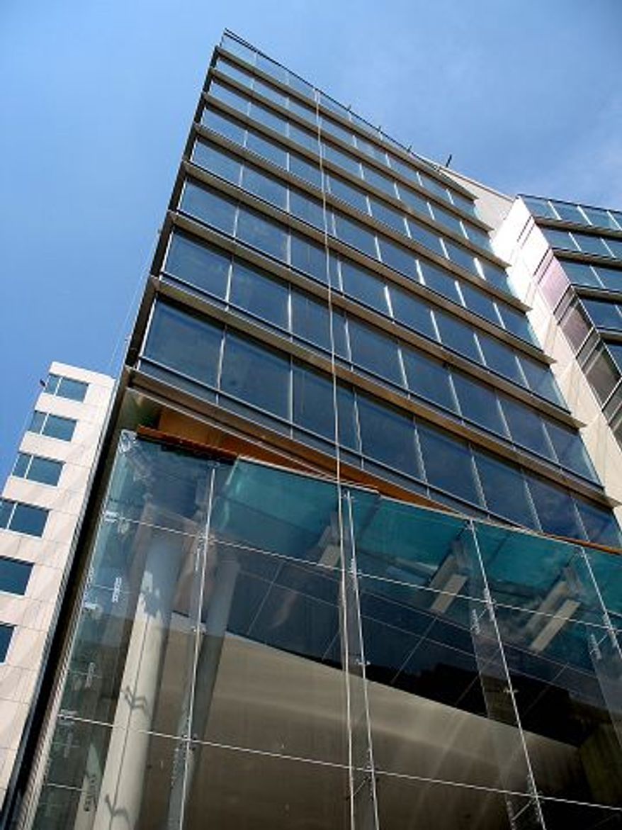 The Shakespeare Theatre Company's Sidney Harman Hall (above), which opens Oct. 1, has a three-story projecting glass bay that acts as a marquee. Hickok Cole Architects of the District designed the new 12-story Columbia Center on 15th Street Northwest (left) with various types of glass to give a transparent look.