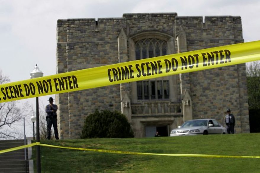** FILE ** Police tape surrounds Virginia Tech's Norris Hall on April 18, 2007, two days after Seung-hui Cho killed 30 people there. (AP Photo, File)