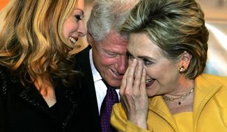 **FILE** Sen. Hillary Rodham Clinton shares a light moment with her husband, former President Bill Clinton, and their daughter, Chelsea, during a rally for her supporters in Ponce, Puerto Rico.