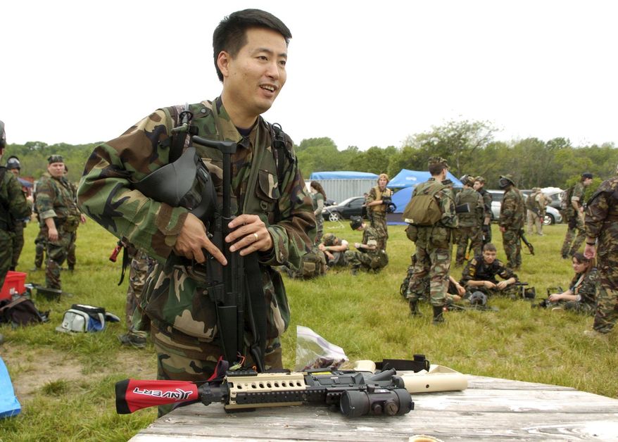 ** FILE ** Michael Kim of Columbia, Md., prepares for his first airsoft game. Many participants have military experience or are in law enforcement and play to keep their skills sharp. (The Washington Times)