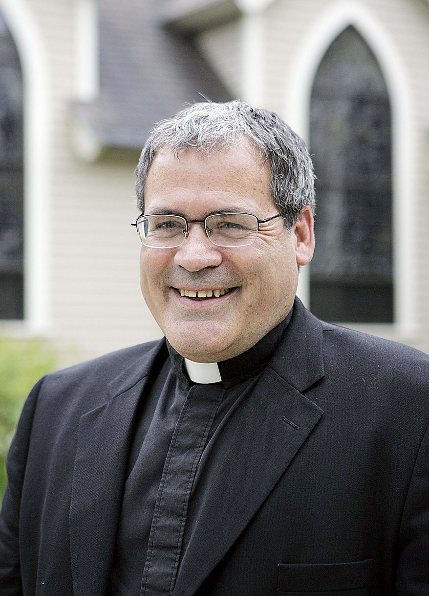 ** In this June 18, 2008, file photo, the Rev. John McLaughlin, of St. Monica Parish in Methuen, Mass., is the first national vocations director at the Archdiocese of the Military in Washington. This month, Father McLaughlin begins traveling the country to recruit members of the military into the Catholic priesthood and sisterhood. (Associated Press)