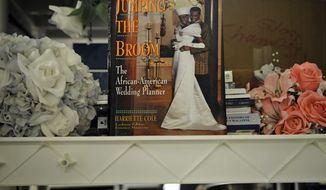 **FILE** Silk flowers and wedding-planning guides are among the items available at St. Anthony&#39;s Bridal in Bethesda, a one-stop lending shop for engaged couples. (The Washington Times)