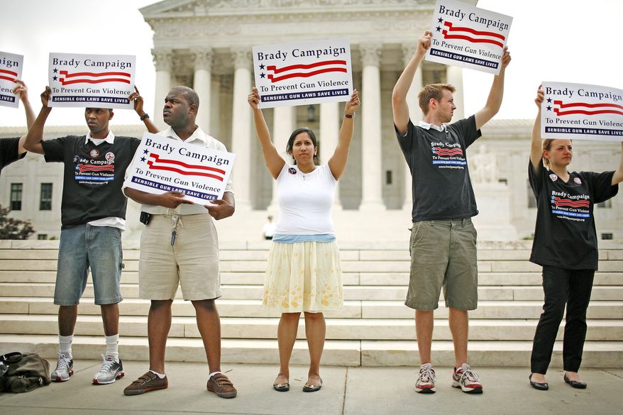 Photographs by Katie Falkenberg/The Washington Times
Gun-control activists in front of the Supreme Court show their support for the gun ban and the Brady Campaign to Prevent Gun Violence.