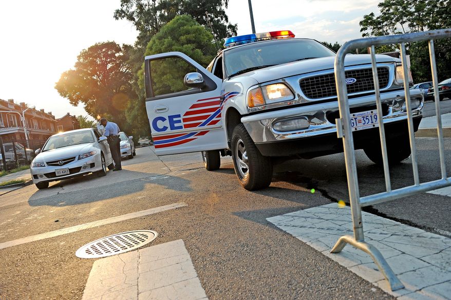 Metropolitan Police arrested a suspect Saturday in a triple homicide on Holbrook Street in Northeast. (Allison Shelley/The Washington Times)