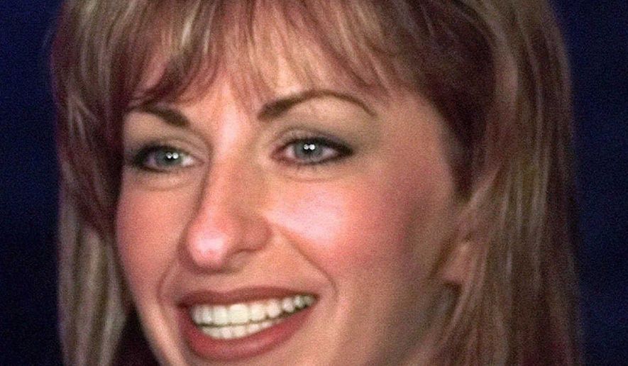 Paula Jones smiles during a news conference in Dallas, in this April 16, 1998, file photo. Encouraged by an outside lawyer, Paula Jones is ready to insist on $2 million, half from President Clinton and half from a New York tycoon, in exchange for dropping her sexual harassment lawsuit, two legal sources involved in the case said Saturday, Oct. 17, 1998. (AP Photo/LM Otero) ** FILE **