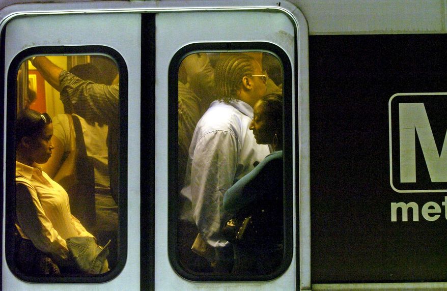 **FILE** Rush-hour commuters ride a Metrorail train in the District. (Associated Press)