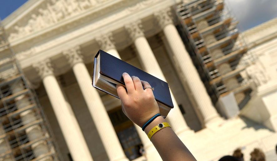 Dozens of youths from different parts of the country rally around an upheld Bible signaling a silent pro-life prayer in front of the Supreme Court. **FILE**