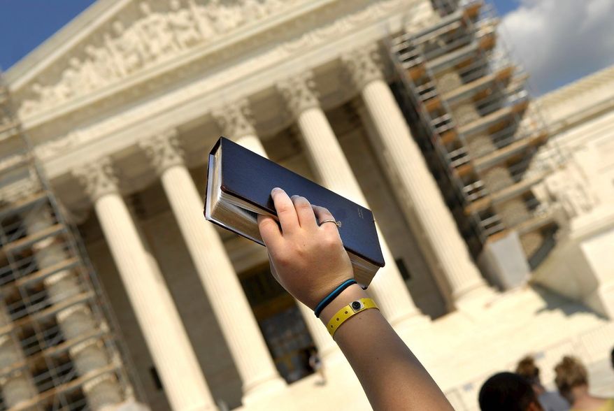 Dozens of youths from different parts of the country rally around an upheld Bible signaling a silent pro-life prayer in front of the Supreme Court.