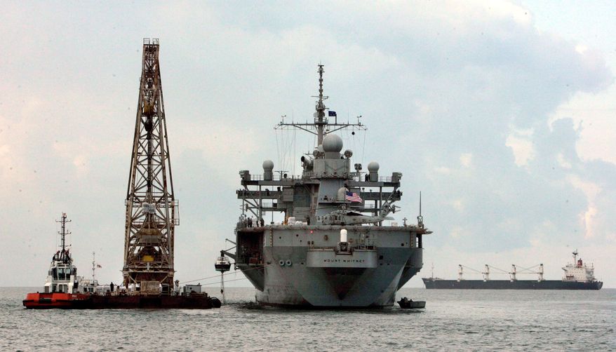 DELIVERY: The USS Mount Whitney unloads aid in Poti, Georgia, on Saturday. Russian forces that invaded Georgia seized more than just U.S. Humvees. (Associated Press)