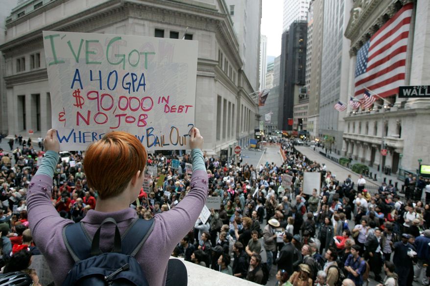 Dara Blumenthal of Brooklyn shows off her personal debt during a rally Thursday on Wall Street against the proposed government bailout. (Associated Press)