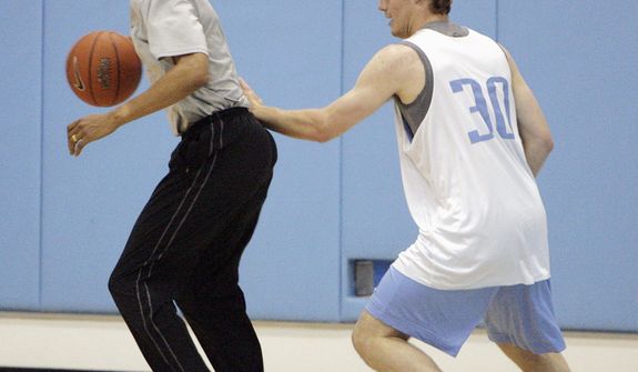 ** FILE ** Then-Democratic presidential nominee Sen. Barack Obama plays basketball with the University of North Carolina&#39;s Jack Wooten in Chapel Hill, N.C., on April 29. (Associated Press)