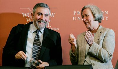 Paul Krugman, a Princeton University professor of economics and a New York Times columnist, is applauded by Princeton President Shirley M. Tilghman after winning the Nobel Prize in economics. (Associated Press) ** FILE **