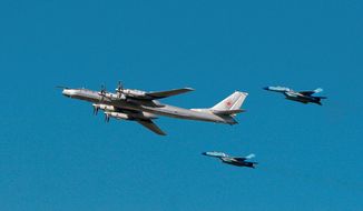 A Russian Tu-95 bomber, surrounded by MiG-29s, participates in an air show marking 95th anniversary of the Russian air forces in August 2007. Coupled with newer long-range missiles, the slower but larger bombers are set to play a role in a modern military. (Agence France-Presse/Getty Images)