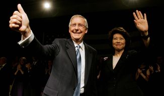 ** FILE ** In this 2008 file photo, Senate Minority Leader Mitch McConnell celebrates his re-election with his wife, Elaine L. Chao, in Louisville, Ky. (Associated Press)