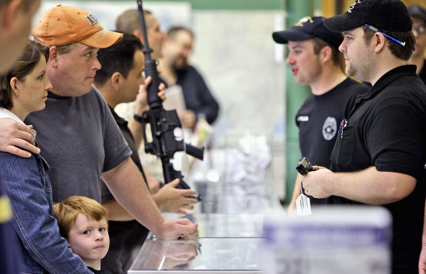 Customers line up to look at firearms at a gun shop in Fort Worth, Texas, Thursday, Nov. 6, 2008. The Cheaper Than Dirt gun store recorded a record day of gun sales the day after the election of President-elect Barack Obama and is having trouble keeping up with the demand for assault riffles. (Associated Press)