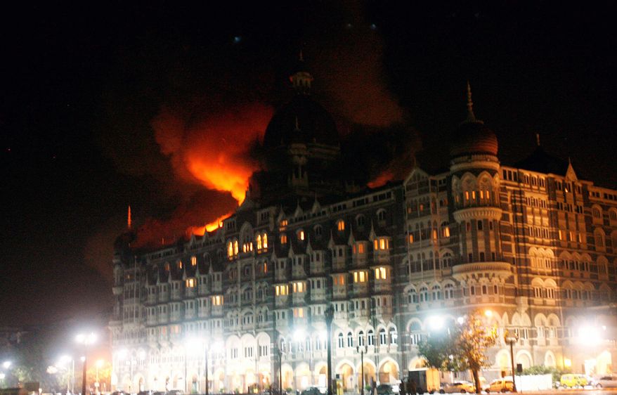 ** FILE ** Fire engulfs a part of the Taj Hotel in Mumbai, India, early Thursday, Nov. 27, 2008. Teams of heavily armed gunmen stormed luxury hotels, a popular restaurant, hospitals and a crowded train station in coordinated attacks across India&#39;s financial capital Wednesday night, killing at least 78 people and taking Westerners hostage, police said. A previously unknown group, apparently Muslim militants, took responsibility for the attacks. (AP Photo/Gautam Singh)