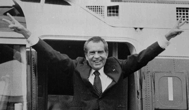 President Nixon waves goodbye to staff members outside the White House after resigning on Aug. 9, 1974, following revelations of the Watergate and other scandals. 
