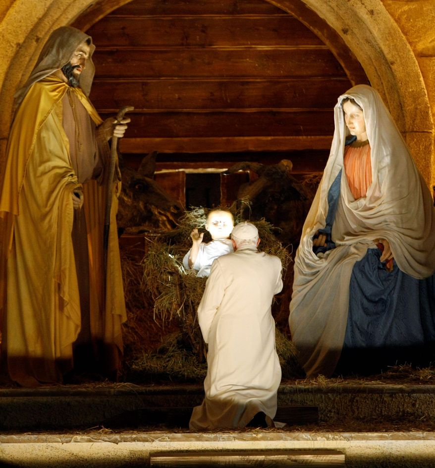 ** FILE ** Pope Benedict XVI visits the Nativity scene after a New Year's Eve Vespers service at St. Peter's Basilica at the Vatican in 2008.