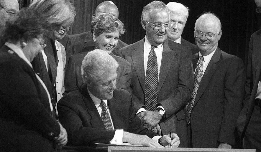 President Clinton is surrounded by several members of Congress who supported the Long-Term Care Security Act as he signs it into law in September 2000.