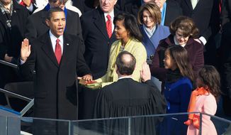 ** FILE ** Barack Obama takes the oath of office, becoming the 44th president of the United States and the first black person to hold the position on Jan. 20, 2009. He is joined on the Capitol steps by wife Michelle and daughters Malia (second from right) and Sasha. He was sworn in using the Bible from Abraham Lincoln&#39;s first inauguration, in 1861. (J.M. Eddins Jr./The Washington Times)