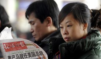Agence France-Presse/Getty Images
A woman reading a newspaper on Wednesday in Beijing will not find President Obama&#39;s entire speech; the state news agency cut a reference to facing down &quot;fascism and communism.&quot;