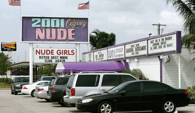 ** FILE ** 2001 Odyssey, a strip club in the Tampa, Fla., area. Citizens of Stone Park, Ill., are fighting a similar club&#x27;s attempts to open next-door to a convent. (Associated Press)