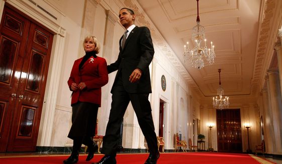 President Obama walks with Lilly Ledbetter to the East Room of the White House where he signed the equal-pay bill into law in the presence of lawmakers, Vice President Joseph R. Biden Jr. and Secretary of State Hillary Rodham Clinton. (Photograph by Katie Falkenberg/The Washington Times)