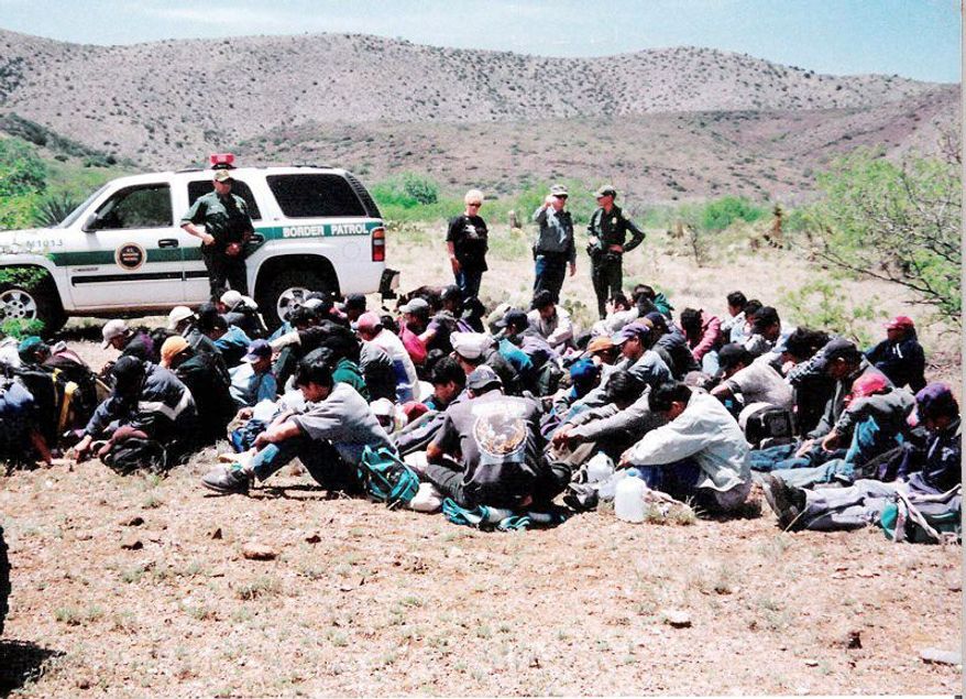 Roger Barnett and wife Barbara survey a group of illegal immigrants they stopped on their Arizona ranch and turned over to the U.S. Border Patrol in spring 2009. Over the past decade, Arizona has developed into the most popular entry point for border-crossers, and consequently, the state has become the most aggressive in trying to deter illegal immigration. (Special to The Washington Times)