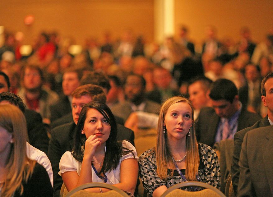 Katie Falkenberg/The Washington Times
Two young women listen attentively to a speaker Thursday at the three-day Conservative Political Action Conference in Washington.