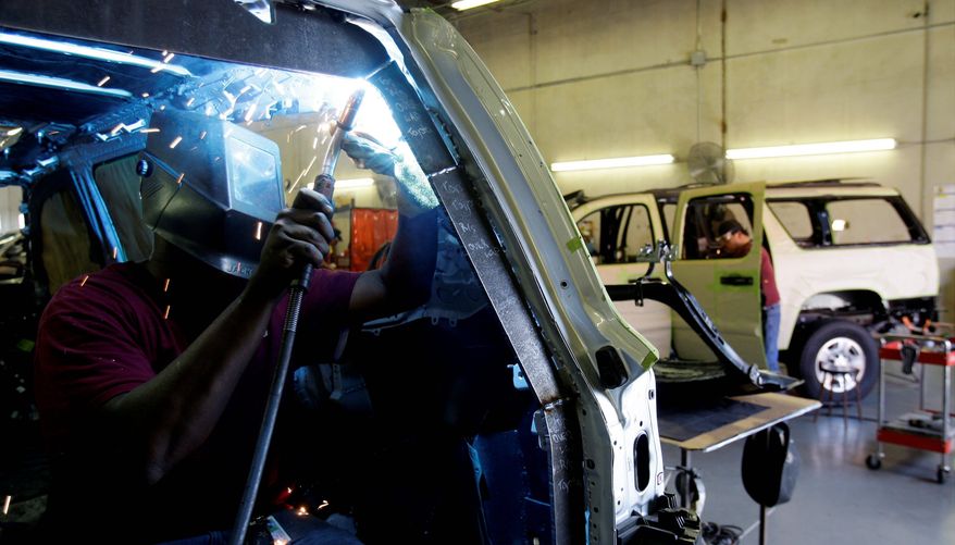 A worker attaches armor plates to a vehicle in San Antonio. Fear of killings and kidnappings along the U.S.-Mexico border has prompted residents to modify their cars. (Associated Press)
