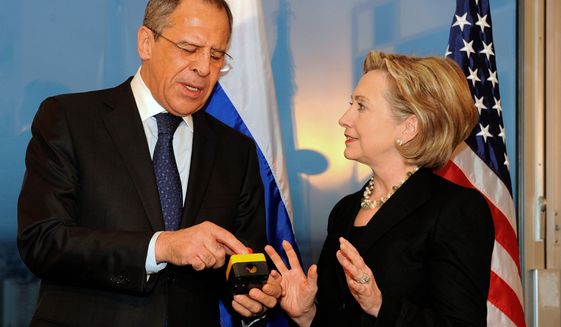 Former Secretary of State Hillary Rodham Clinton presents Russian Foreign Minister Sergey Lavrov with a &quot;reset button&quot; during their meeting in Geneva in 2009. (Associated Press) ** FILE **