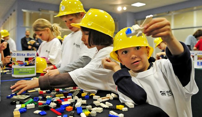 Andy Zarate enjoys his Lego airplane as his sister Katie gets started. Children between 7 and 17 were given 400 pieces to build with at the Montgomery Mall in Bethesda, Md, Sunday. (Joseph Silverman/ The Washington Times)
