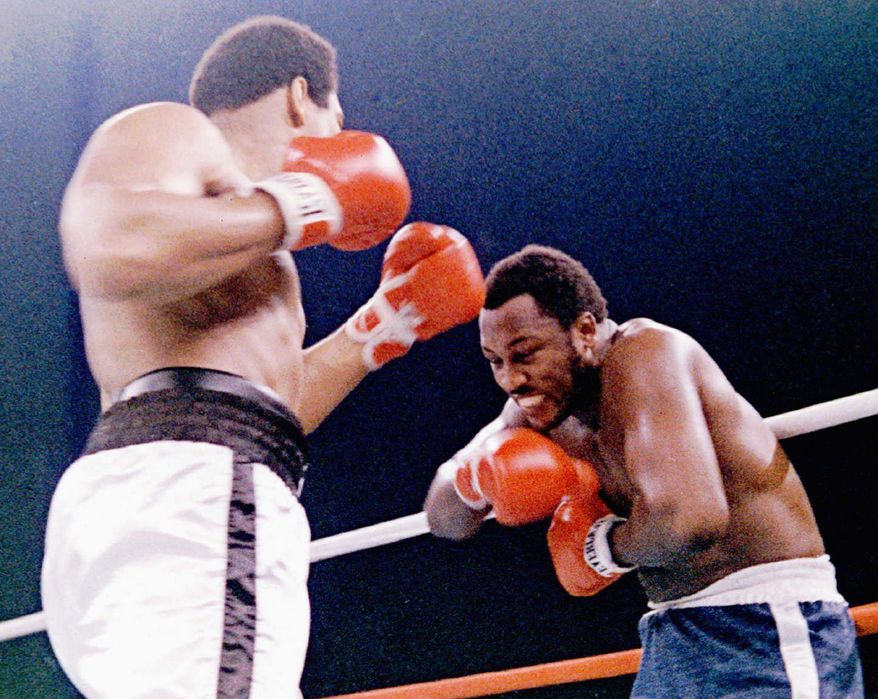 Joe Frazier (right) and Muhammad Ali met for their third - and most physical - match in Manila in 1975. (Associated Press)