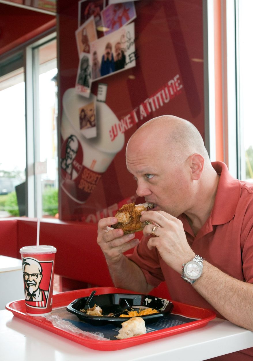** FILE ** Mike Ash of Louisville, Ky., home of the original Kentucky Fried Chicken chain, samples the restaurant's new grilled chicken entree. (Associated Press)