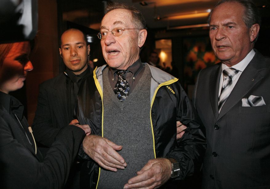 Harvard law professor Alan Dershowitz (center) is led away Sunday after declaring he planned to challenge Iranian President Mahmoud Ahmadinejad about his views on the Holocaust and Israel minutes before the meeting with Swiss President Hans-Rudolf Merz and Iranian President Ahmadinejad in Geneva, Switzerland. The United Nations opens its first global racism conference in eight years on Monday with the U.S. and at least five other countries boycotting the event out of concern that Islamic countries will demand that they denounce Israel and ban criticism of Islam. (Associated Press) ** FILE **