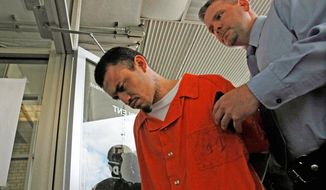 ASSOCIATED PRESS
Ingmar Guandique, 27, accused of the 2001 slaying of Chandra Levy in Rock Creek Park, is escorted Wednesday into the D.C. police department&#39;s violent crimes unit by Detective Todd Williams. Guandique is expected to appear Thursday in D.C. Superior Court.
