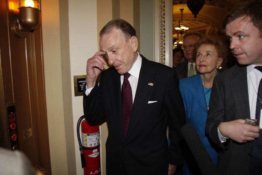 Republican Senator Arlen Specter of Pennsylvania walks through the hallway outside of the Senate chamber in the U.S. Capitol in Washington Tuesday, April 28, 2009. Specter announced he is switching political parties and will be become a Democrat. (AP Photo/Harry Hamburg)