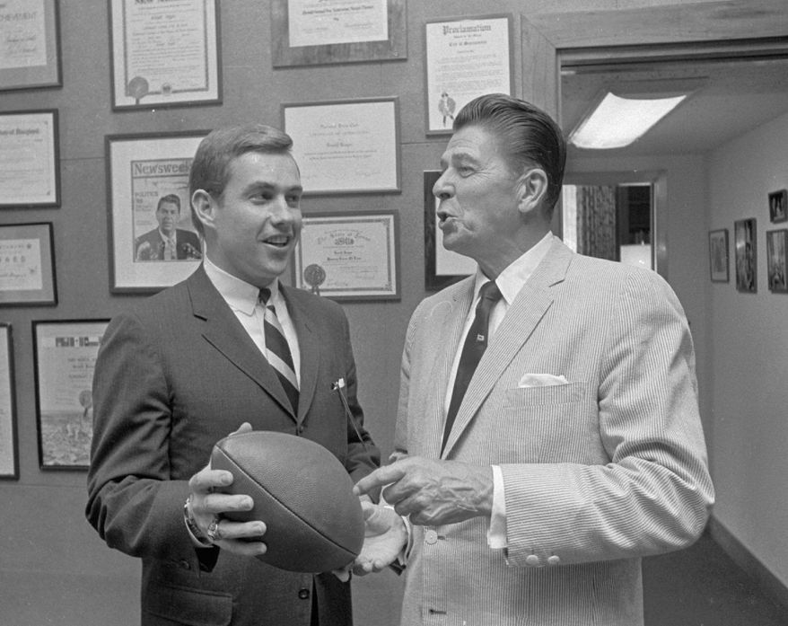 ASSOCIATED PRESS
Jack Kemp trades football jabs with then-California Gov. Ronald Reagan in his Sacramento office in 1967. Mr. Kemp, a former quarterback and congressman, has been called one of Reagan's "biggest cheerleaders."