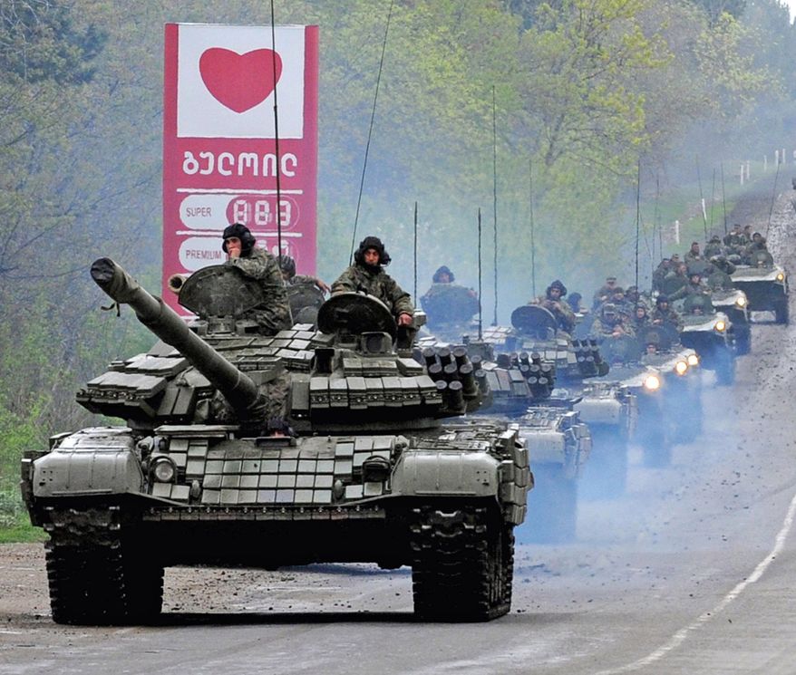 Georgian tanks move along a road outside the capital, Tbilisi.