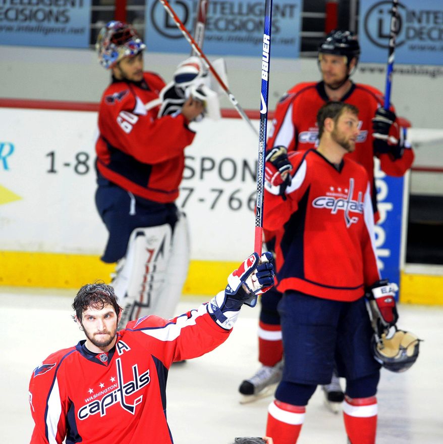 Michael Connor/The Washington Times
Alex Ovechkin (lower left) of the Washington Capitals acknowledges fans Wednesday night after the Pittsburgh Penguins defeated the Caps 6-2 in the seventh and deciding game of the NHL's Eastern Conference semifinals at the Verizon Center. "We're disappointed," Ovechkin said of the season-ending loss.