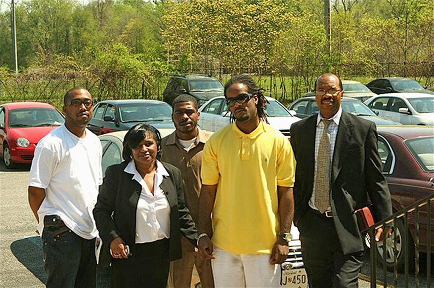 Mentor Debra Rowe escorts Jason Wren (center) into Providence St. John Baptist Church as part of a program to keep citizens on the right path after incarceration. They are accompanied (from left) by Reginald Hutchinson, Ms. Rowe's son, Alphonso Allen, and Andre Tillman. (James C. Allen)
